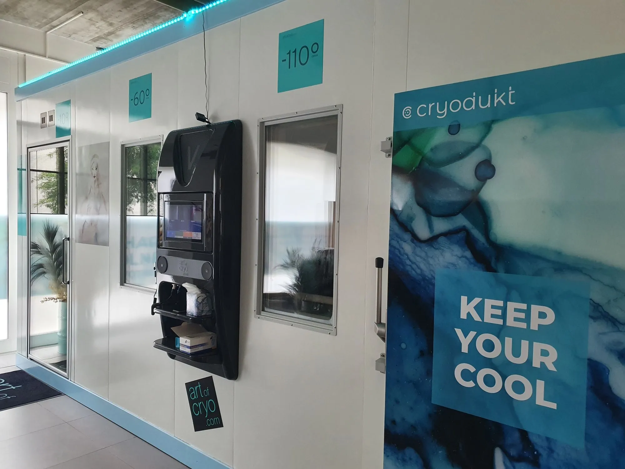 Entrance to a cryotherapy chamber with Keep Your Cool wall art