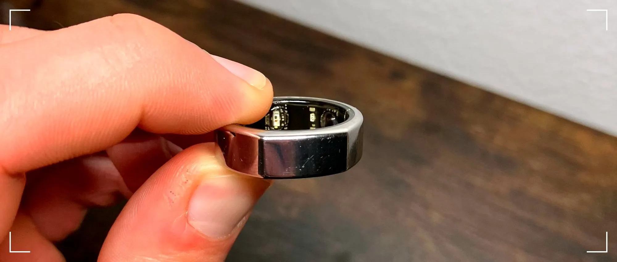 Oura Ring held between fingers