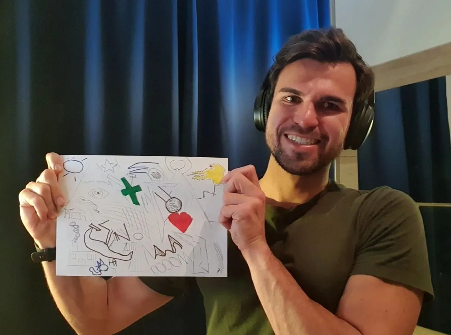 Person holding up a handdrawn artwork