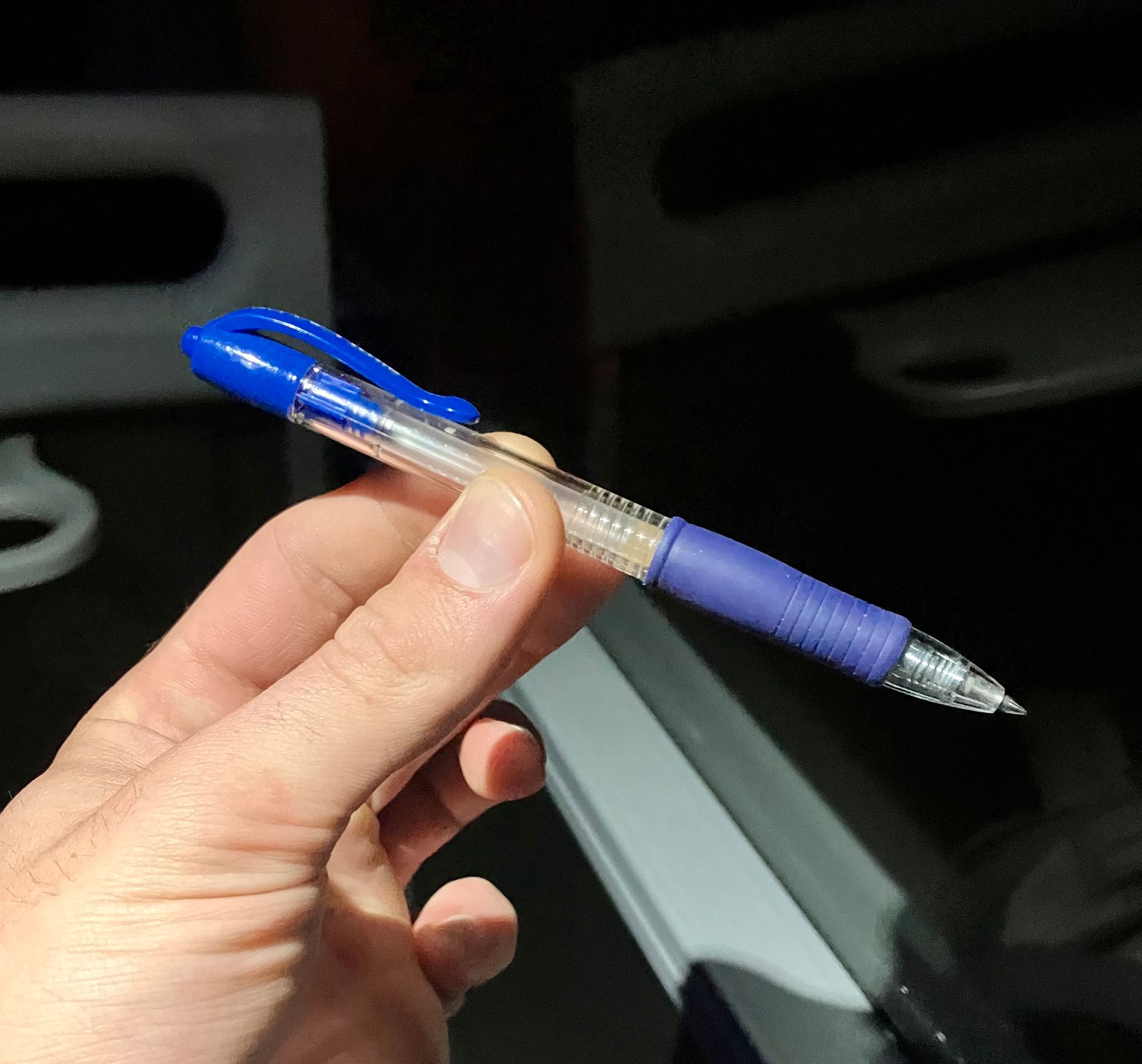 holding a blue pen in my hand