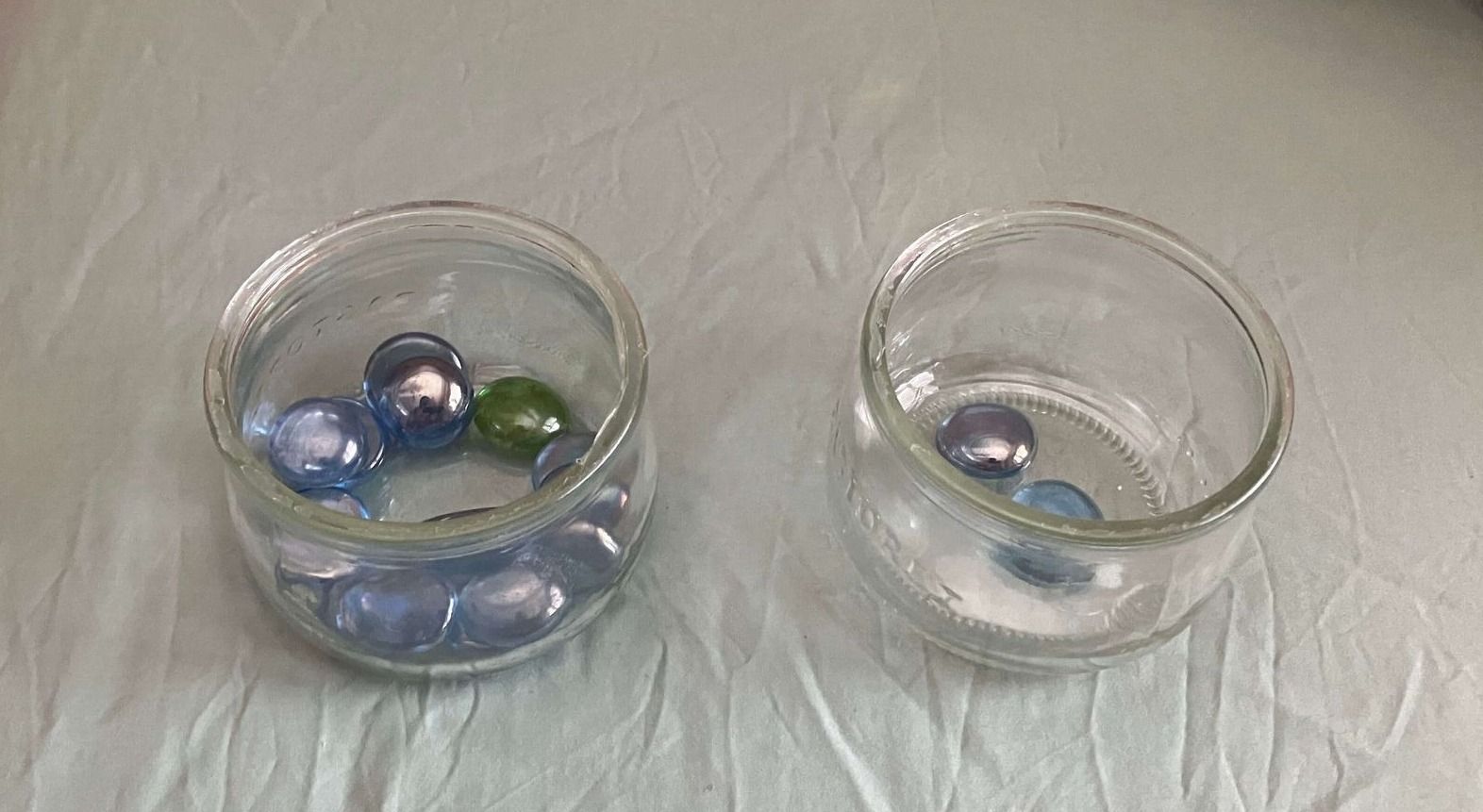 17 marbles in the left glass and 2 marbles in the right glass