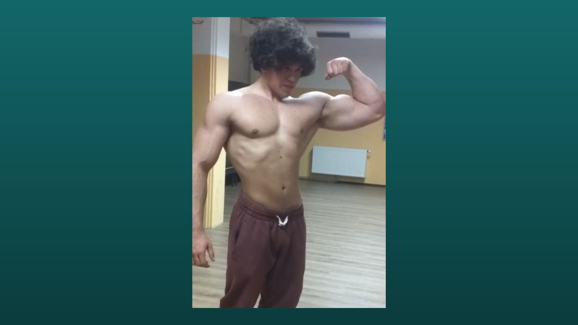 flexing in front of the mirrow with an old school biceps pose